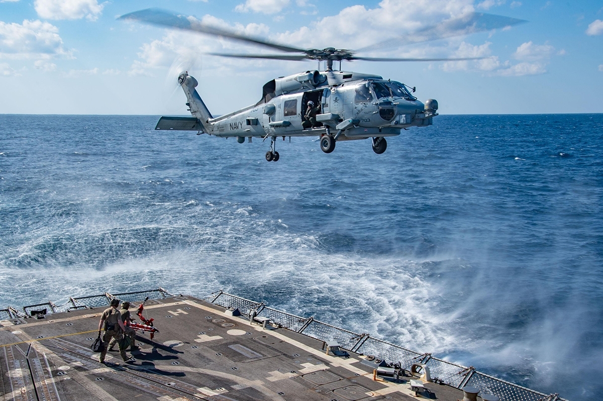 Navy helicopter landing on ship