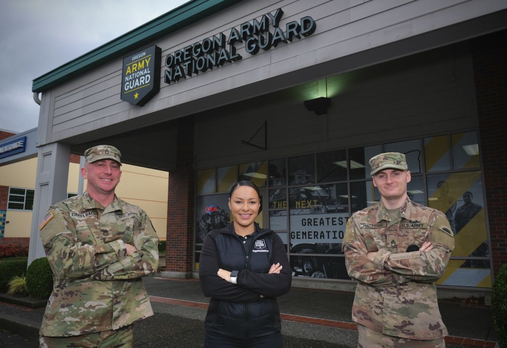 Three recruiters standing outside new recruiting office.